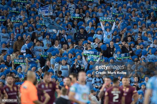 Blues supporters in the crowd cheer during game two of the State Of Origin series between the New South Wales Blues and the Queensland Maroons at ANZ...