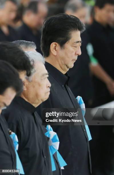 Japanese Prime Minister Shinzo Abe observes a moment of silence during a ceremony to mark the 72nd anniversary of the end of a fierce World War II...