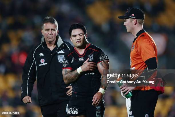 Issac Luke of the Warriors comes off the field with an injury with Warriors team doctor John Mayhew during the round 16 NRL match between the New...