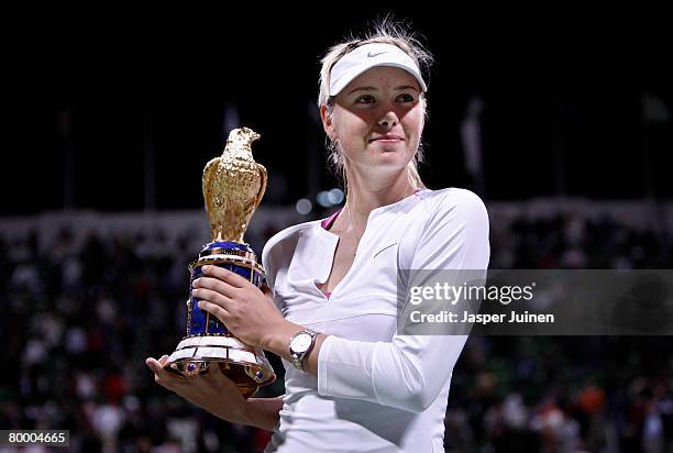 Maria Sharapova of Russia holds up the Golden Falcon award after winning her WTA Qatar Total Open final match against Vera Zvonareva of Russia on day...