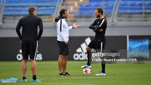 Anthony Hudson, head coach of New Zealnd talks with Andrew Durante during a training session of the New Zealand national football team on June 23,...