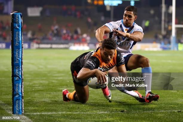 Esan Marsters of the Tigers scores try in the corner during the round 16 NRL match between the Wests Tigers and the Gold Coast Titans at Campbelltown...