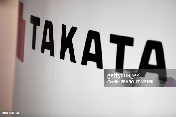 Logo of the Japanese auto parts maker Takata is seen a car showroom in Tokyo on June 23, 2017. - Takata shares swung wildly rebounding by 45 percent...