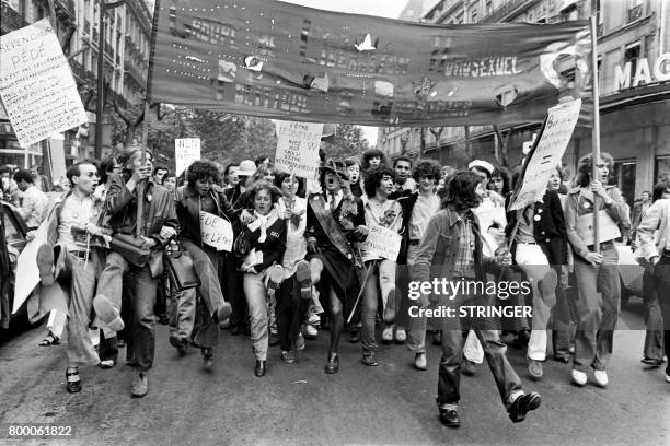 File picture taken on June 25, 1977 shows people holding signs and a banner reading 'Homosexual Liberation Group, Politics and daily life' during the...