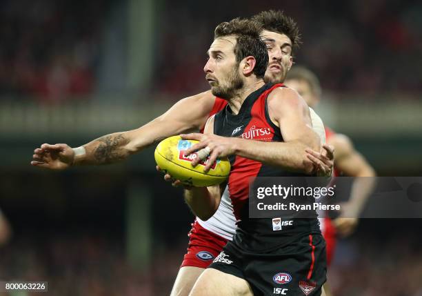 Jobe Watson of the Bombers is tackled by Sam Naismith of the Swans during the round 14 AFL match between the Sydney Swans and the Essendon Bombers at...