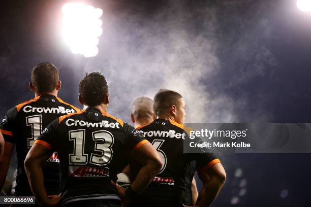 Steam rises off the West Tigers players as they look dejected after a Titan try during the round 16 NRL match between the Wests Tigers and the Gold...