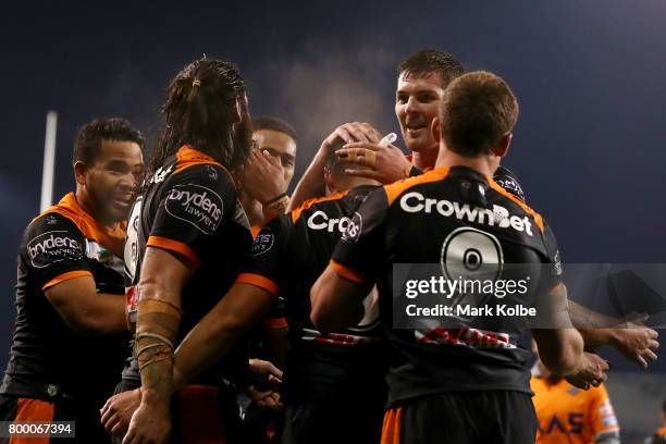 The Tigers players celebrate David Nofoaluma scoring a try during the round 16 NRL match between the Wests Tigers and the Gold Coast Titans at...