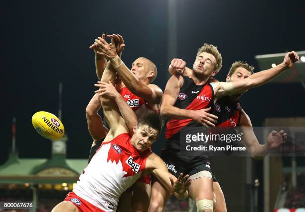 Callum Sinclair and Sam Reid of the Swans competes for the ball against Martin Gleeson and Tom Bellchambers of the Bombers during the round 14 AFL...