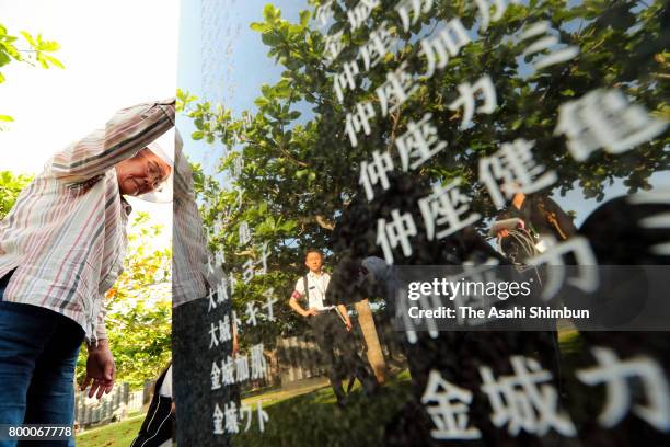 Man prays in front of the Cornerstone of Peace where the names of their bereaved family members and relatives engraved at the Peace Memorial Park on...