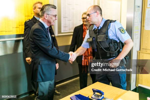 German Interior Minister Thomas de Maiziere talks to police officers during his visit to the police station of German Bundespolizei or Federal Police...