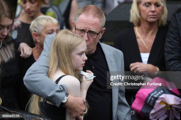 Steve Howe, the husband of Manchester attack victim Alison Howe, embraces family members as Alison's funeral cortege leaves St Anne's Church on June...