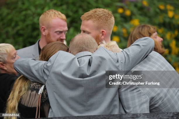 Steve Howe, the husband of Manchester attack victim Alison Howe, embraces family members as Alison's funeral cortege leaves St Anne's Church on June...