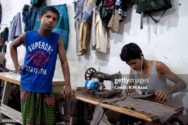 Abdullah stitches a cloth in a local garment shop in Dhaka, Bangladesh. World Day Against Child Labor was observed on 12 June across the world to...