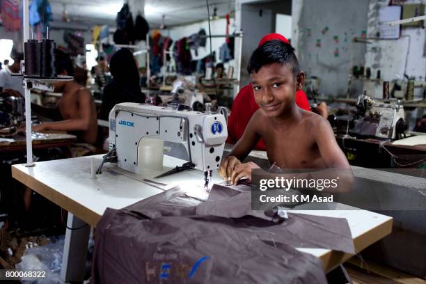 Fazul sews a cloth in a local garment shop in Dhaka, Bangladesh. World Day Against Child Labor was observed on 12 June across the world to raise...