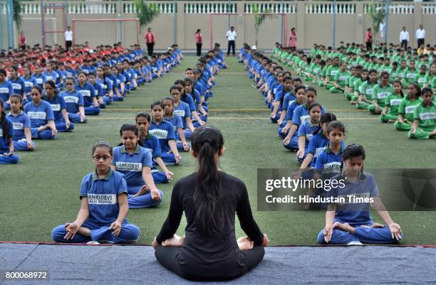 Students of Jankidevi Public School take part in a mass yoga session on the International Yoga Day at The SV Patel Nagar, Andheri West, on June 21,...