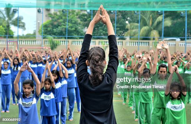 Students of Jankidevi Public School take part in a mass yoga session on the International Yoga Day at The SV Patel Nagar, Andheri West, on June 21,...