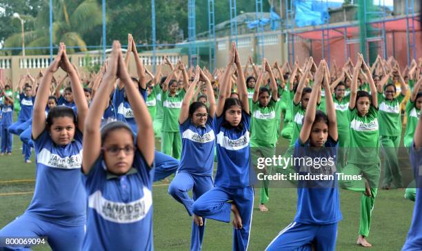 Students of Jankidevi Public School take part in a mass yoga session on the International Yoga Day at The SV Patel Nagar, Andheri West, on June 21,...