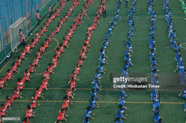 Students of Jankidevi Public School take part in a mass yoga session on the International Yoga Day at The SV Patel Nagar, Andheri West, on June 21,...