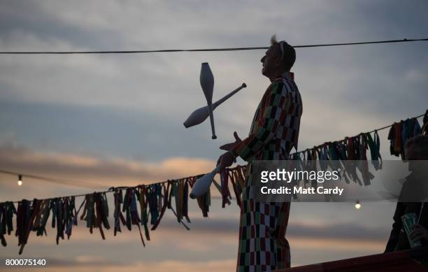 Juggler performs at the Glastonbury Festival site at Worthy Farm in Pilton on June 22, 2017 near Glastonbury, England. Glastonbury Festival of...