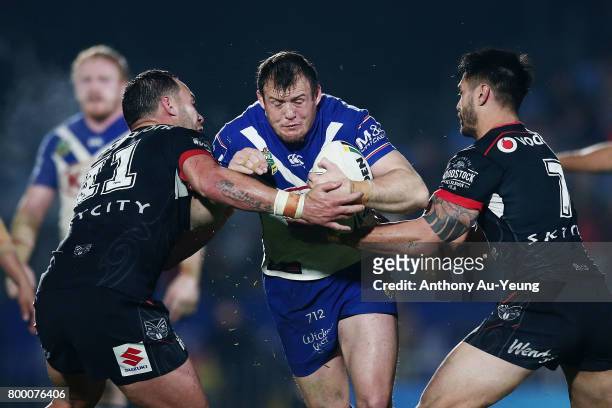Josh Morris of the Bulldogs is tackled by Bodene Thompson of the Warriors during the round 16 NRL match between the New Zealand Warriors and the...