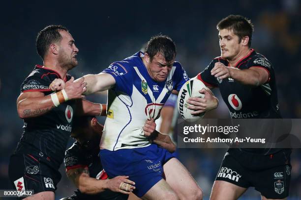 Josh Morris of the Bulldogs is tackled by Bodene Thompson of the Warriors during the round 16 NRL match between the New Zealand Warriors and the...