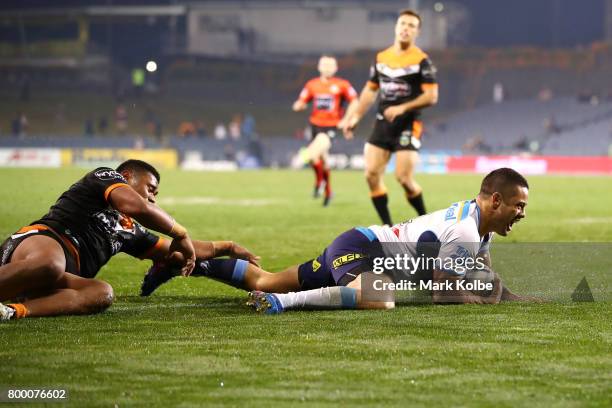 Jarryd Hayne of the Titans scores a try during the round 16 NRL match between the Wests Tigers and the Gold Coast Titans at Campbelltown Sports...