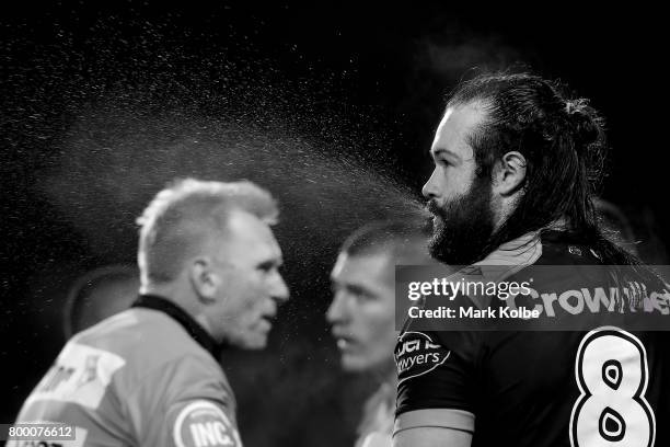 Aaron Woods of the Tigers spits water during the round 16 NRL match between the Wests Tigers and the Gold Coast Titans at Campbelltown Sports Stadium...