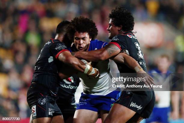 Raymond Faitala-Mariner of the Bulldogs charges against Sam Lisone and James Gavet of the Warriors during the round 16 NRL match between the New...