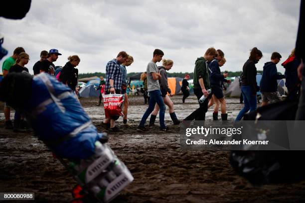 Festival goers arrive at the camp site of the Hurricane Festival 2017 after a night full of heavy rain and winds on June 23, 2017 in Scheessel,...