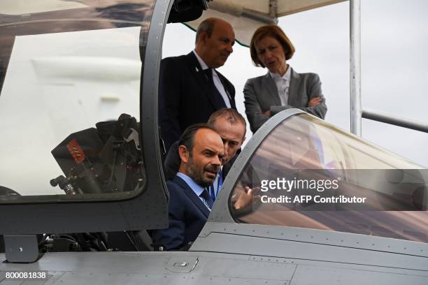 French Prime Minister Edouard Philippe sits in a Dassault Aviation Rafale fighter jet during a visit to the International Paris Air Show in Le...