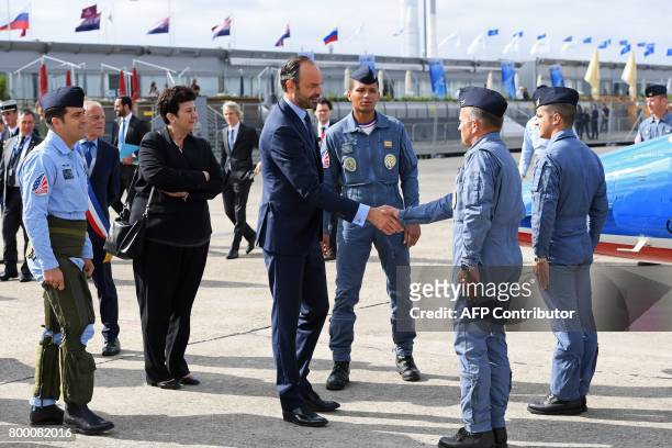French Prime Minister Edouard Philippe shakes hands with pilots from the Patrouille de France during a visit to the International Paris Air Show in...