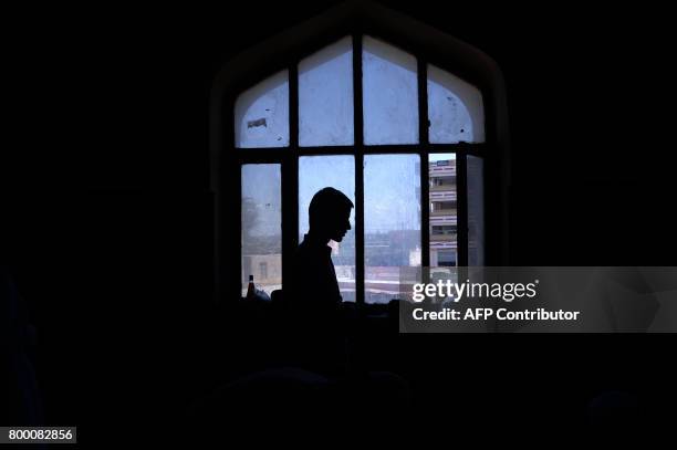 An Afghan Muslim offers his prayers on the last Friday of the holy month of Ramadan ahead of the Muslim festival of Eid al-Fitr, at a mosque in...