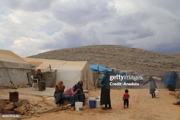 Syrian women fill their buckets with water, during Muslim's holy month of Ramadan in Idlib, Syria on June 23, 2017. Ahead of Eid al Fitr, Syrian...