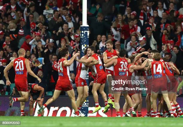 The Swans celebrate after Gary Rohan of the Swans kicked the winning goal after the siren during the round 14 AFL match between the Sydney Swans and...