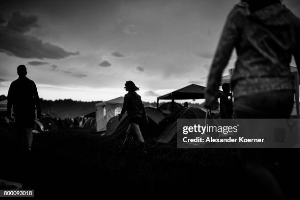 Festival goers walk by the sunset ahead the Hurricane Festival 2017 on June 22, 2017 in Scheessel, Germany. The area of the festival was hit by heavy...