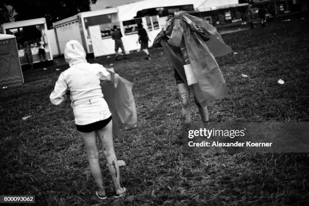 Festival goers in rainjackets are seen at the ahead the Hurricane Festival 2017 on June 22, 2017 in Scheessel, Germany. The area of the festival was...