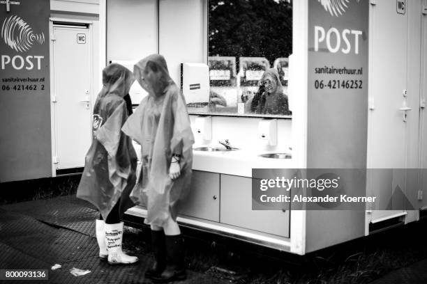 Festival goers in rainjackets are seen at the sanitary installations ahead the Hurricane Festival 2017 on June 22, 2017 in Scheessel, Germany. The...