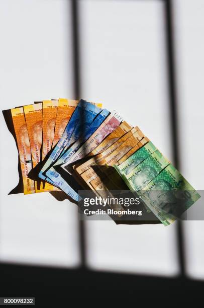 Collection of mixed denomination South African rand banknotes sit in an arranged photo in Johannesburg, South Africa, on Thursday, June 22, 2017....