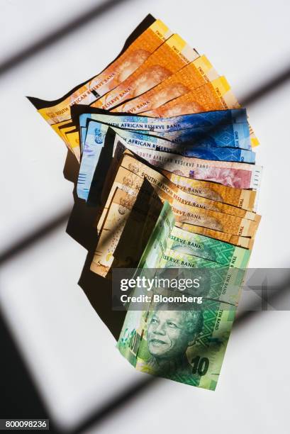 Collection of mixed denomination South African rand banknotes sit in an arranged photo in Johannesburg, South Africa, on Thursday, June 22, 2017....