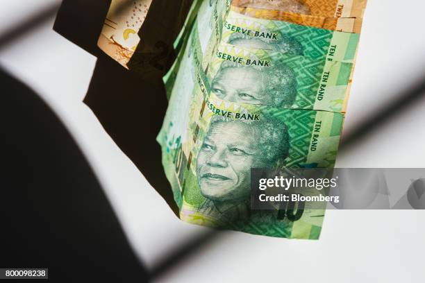 Collection of ten rand South African banknotes sit in an arranged photo in Johannesburg, South Africa, on Thursday, June 22, 2017. South Africas...