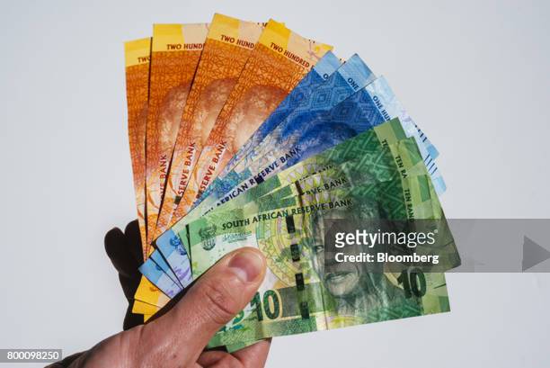Collection of mixed denomination South African rand banknotes sit in an arranged photo in Johannesburg, South Africa, on Thursday, June 22, 2017....