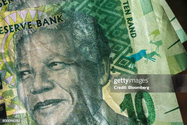 The face of Nelson Mandela, former South African president, sits on a 10 rand South African banknote in an arranged photo in Johannesburg, South...