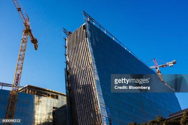Cranes operate at the construction site of new office buildings in the Sandton district of Johannesburg, South Africa, on Thursday, June 22, 2017....