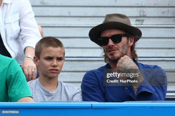 David Beckham and Romeo Beckham watching Sam Querrey during Men's Singles Round Two match on the fourth day of the ATP Aegon Championships at the...