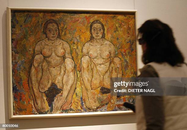 Visitor admires a painting entitled "Hockendes Frauenpaar" by Austrian painter Egon Schiele at the controversial Leopold Museum in Vienna on February...