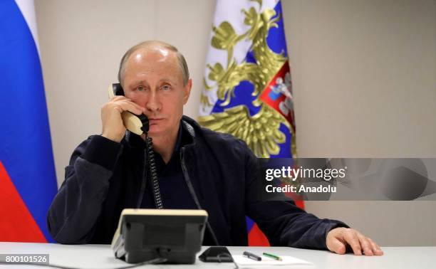 Russian President Vladimir Putin is seen as he makes a telephone conversation with Turkish President Recep Tayyip Erdogan, during his visit in Anapa,...