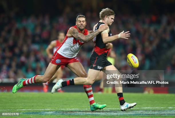 Lance Franklin of the Swans tackles Michael Hurley of the Bombers during the round 14 AFL match between the Sydney Swans and the Essendon Bombers at...