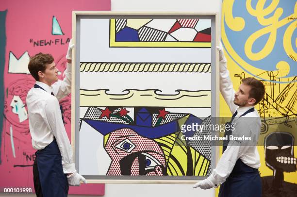 Roy Lichtenstein's Two Paintings with Dado, 1983 is carried in front of two collaborative paintings by Andy Warhol and Jean-Michel Basquiat at...
