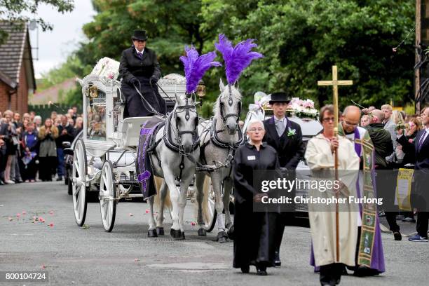 Mourners throw pink carnations as the funeral cortege of Manchester attack victim Lisa Lees leaves St Anne's Church on June 23, 2017 in Oldham,...