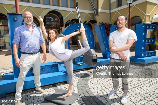 Kay Niehaus , Business Director of the Ingolstadt and Wertheim Village, Jana Pallaske and artist Il-Jin Atem Chio pose next to the sculptures of the...